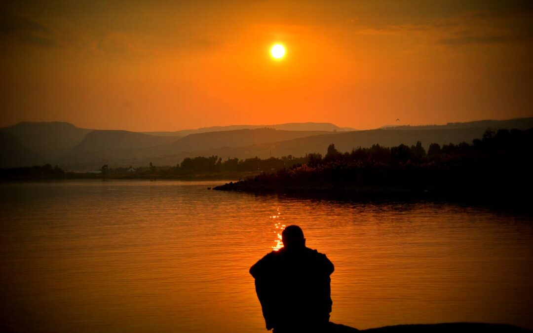 managing-depression-man-sitting-water-sunset